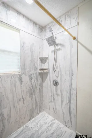 a bathroom with a shower curtain and a shower