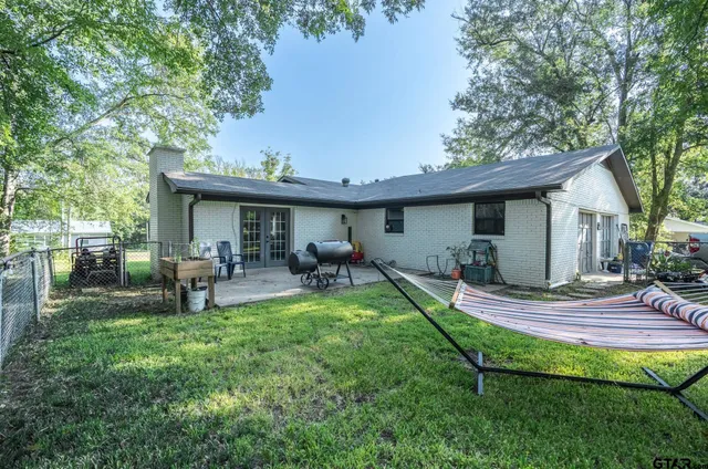 a view of a house with backyard porch and sitting area