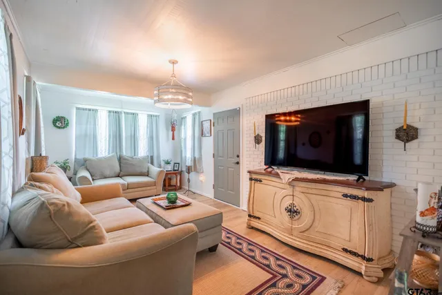 a living room with furniture and a flat screen tv