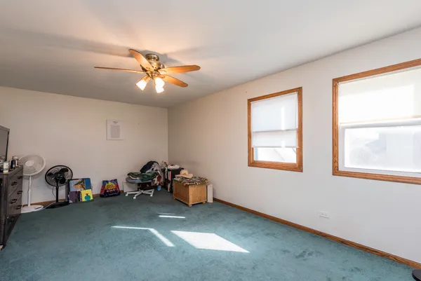 a view of a livingroom with furniture and a ceiling fan