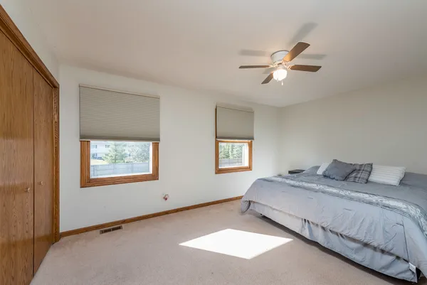 a bedroom with a bed a table and chair