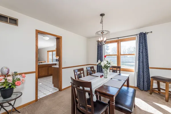 a view of a dining room with furniture window and outside view