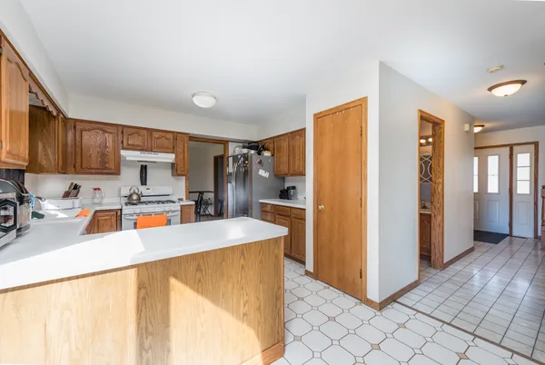 a kitchen with a sink window and cabinets