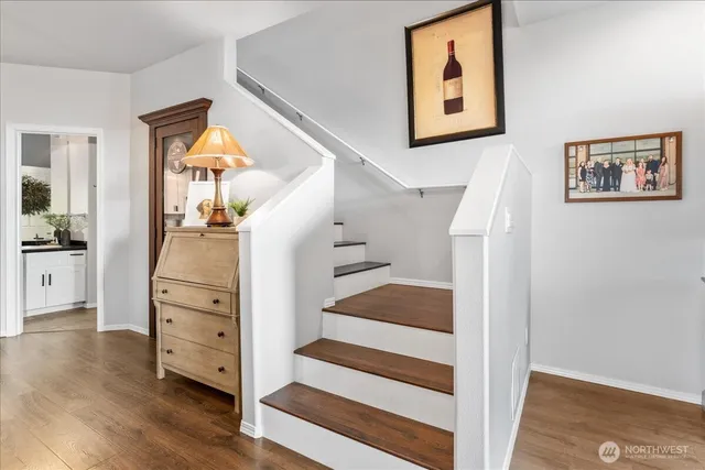 a view of a hallway with windows and wooden floor