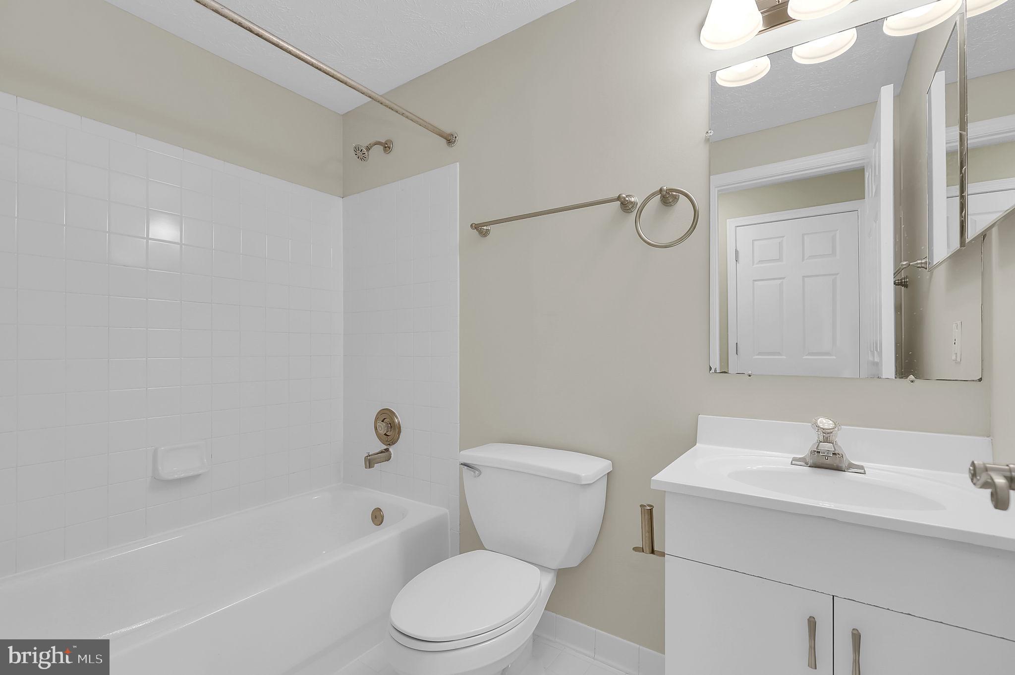 7150 Natures Road Columbia, MD 21046 - Photo 30 of 45 a bathroom with a toilet a sink a mirror a bathtub and vanity