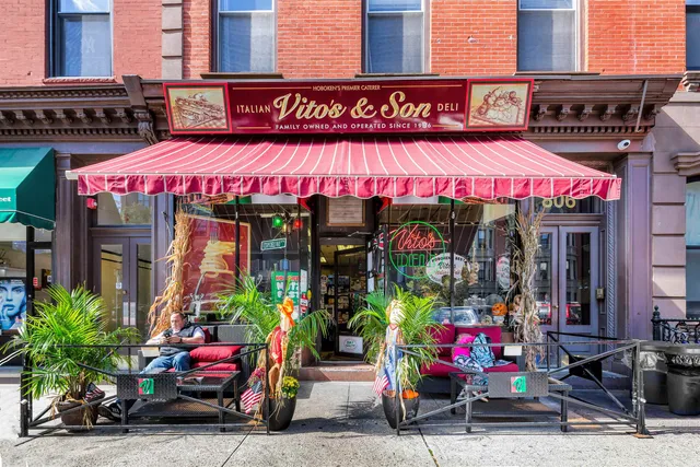 a store with outdoor seating area and signage