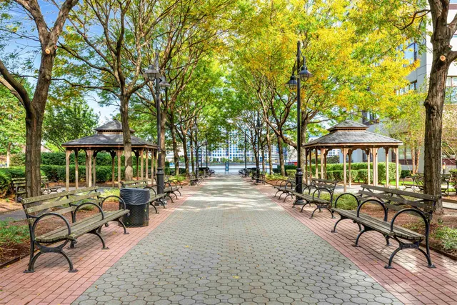 a view of a patio with a table and chairs under an umbrella