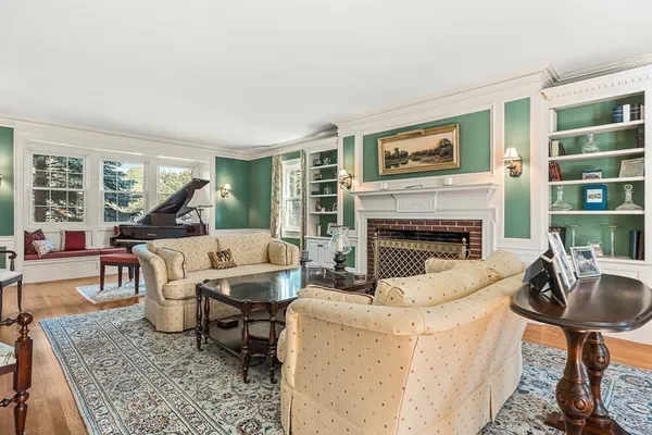 a living room with furniture a table and a fireplace