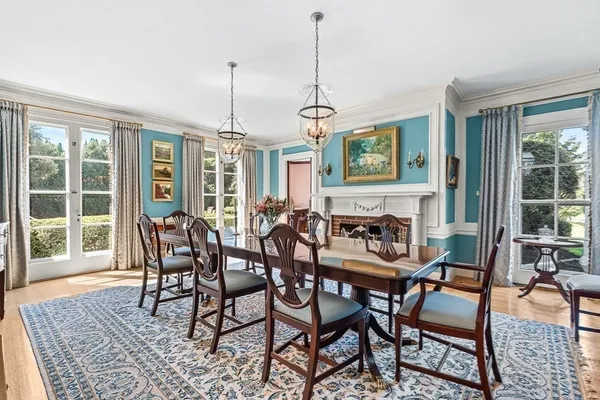 a dining room with furniture a chandelier and wooden floor