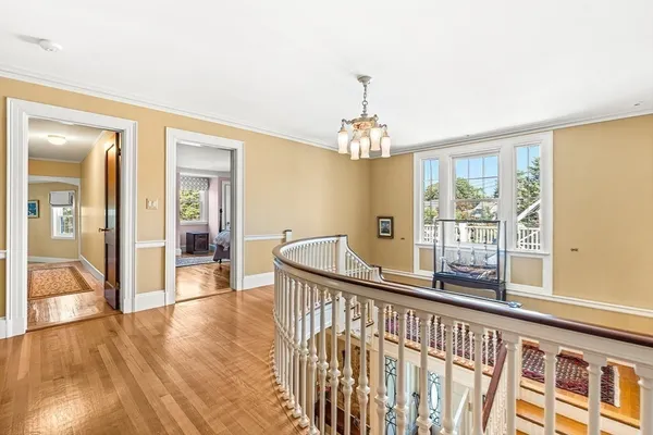 a view of a room with wooden floor and windows
