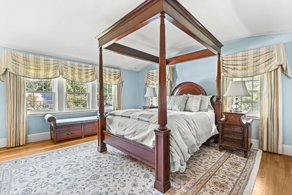 a bedroom with a bed and a large window with the outer view