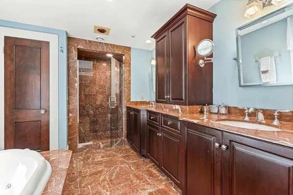 a spacious bathroom with a double vanity sink and a mirror