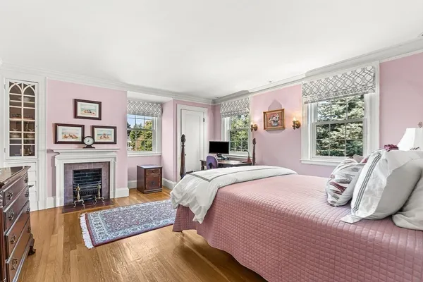 a bedroom with a bed and a fireplace