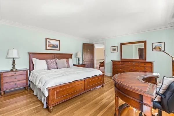 a bedroom with a bed and a dresser in it