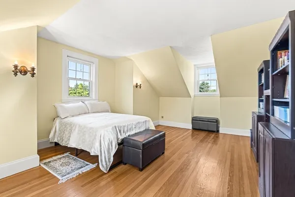 a spacious bedroom with a bed and a book shelf