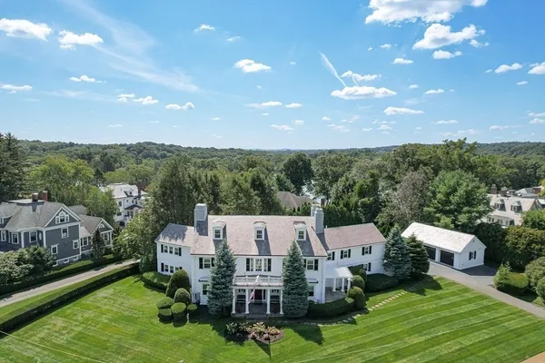 a aerial view of a house with pool patio and outdoor seating