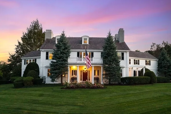 a front view of a house with a garden and plants