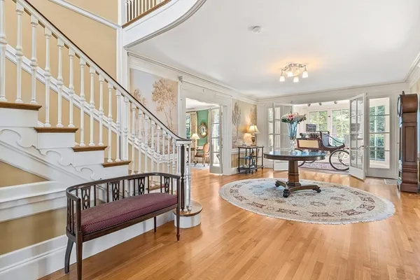 a view of entryway and hall with wooden floor