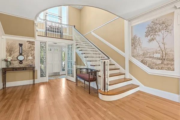 a view of entryway and hall with wooden floor
