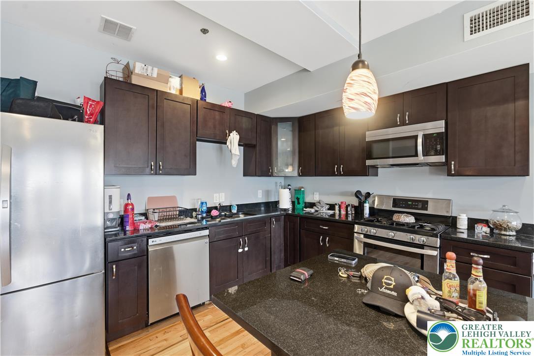 623 Walnut Street, Unit A2 Easton, PA 18042 - Photo 7 of 21 a kitchen with granite countertop a refrigerator stove top oven and sink