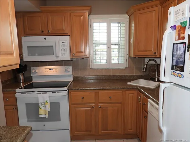 a bedroom with two beds and a chandelier