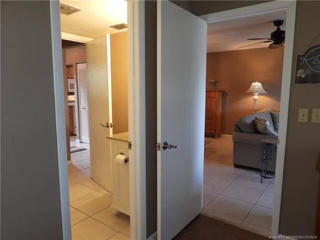 a bedroom with a bed and a large mirror