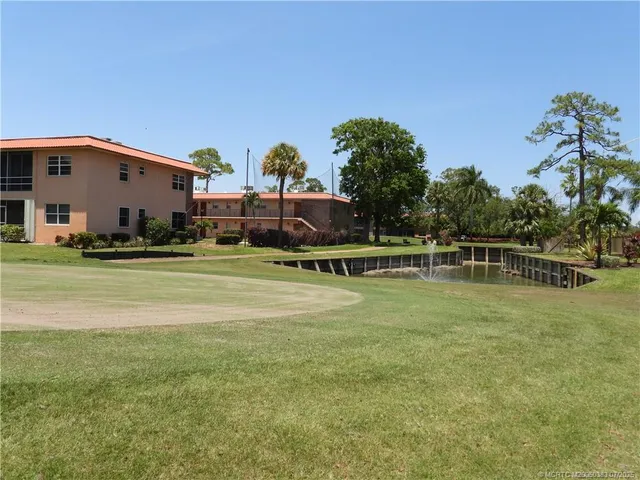 a kitchen with granite countertop a sink a stove and cabinets
