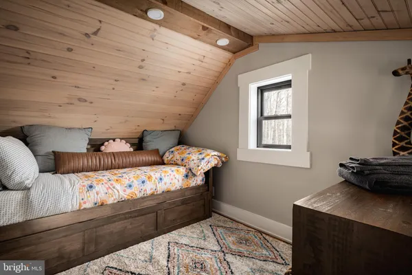 a bedroom with a large bed and a large window