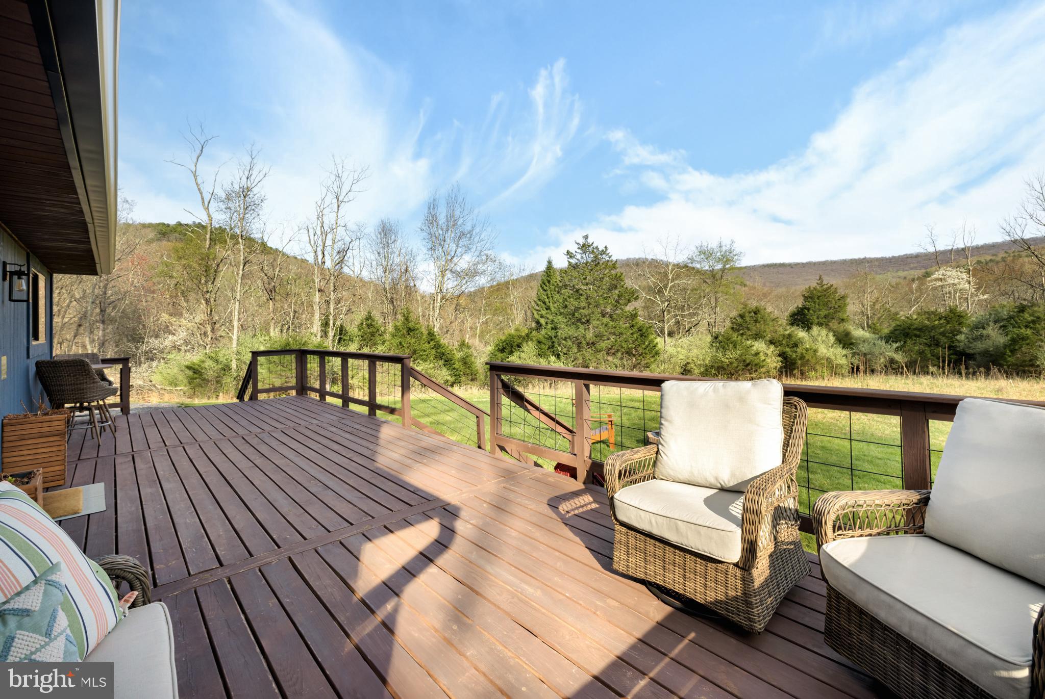 529 Posy Hill Road Lost City, WV 26810 - Photo 41 of 59 a view of a balcony with wooden floor and outdoor seating