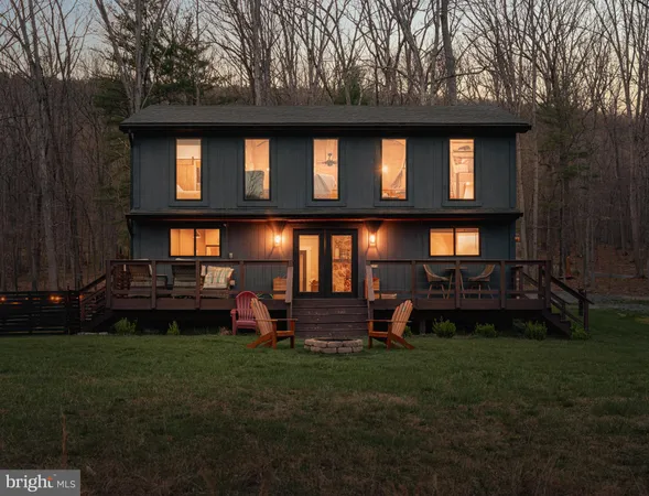 a living room with fireplace furniture and a book shelf