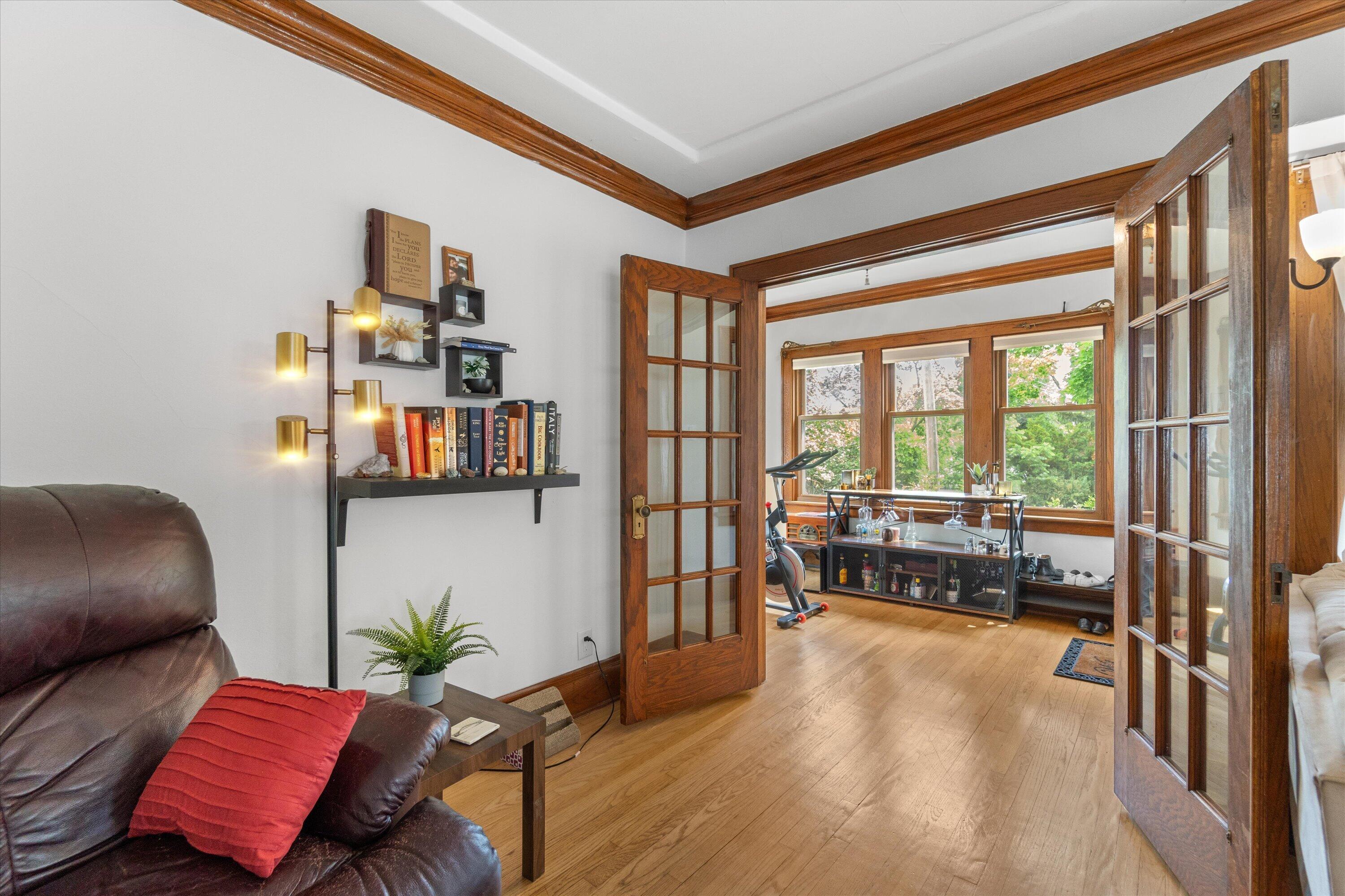 159 North 59th Street Milwaukee, WI 53213 - Photo 28 of 34 Charming living area showcasing classic French doors and warm hardwood floors throughout