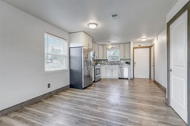 a view of kitchen with wooden floor electronic appliances and window