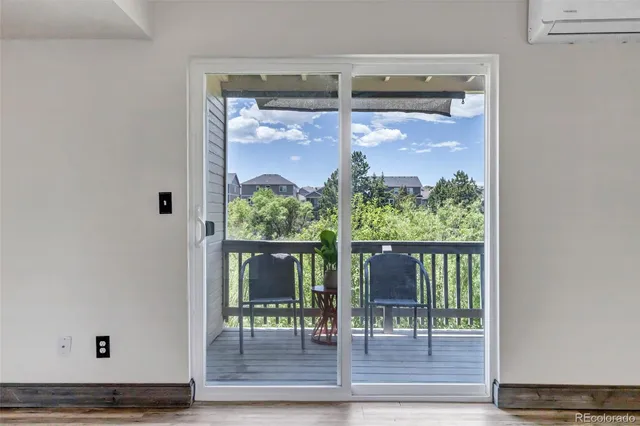 a view of a dining room with furniture a chandelier and wooden floor