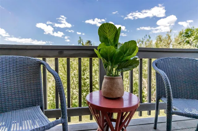 a view of a balcony with furniture
