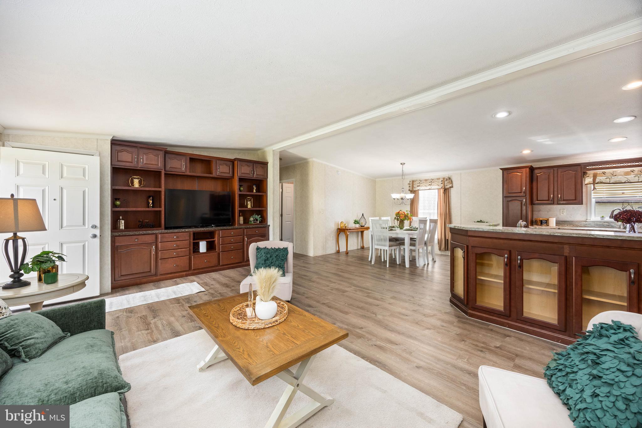 4258 Smith Road Salisbury, MD 21801 - Photo 12 of 43 a living room with furniture a flat screen tv and a kitchen view