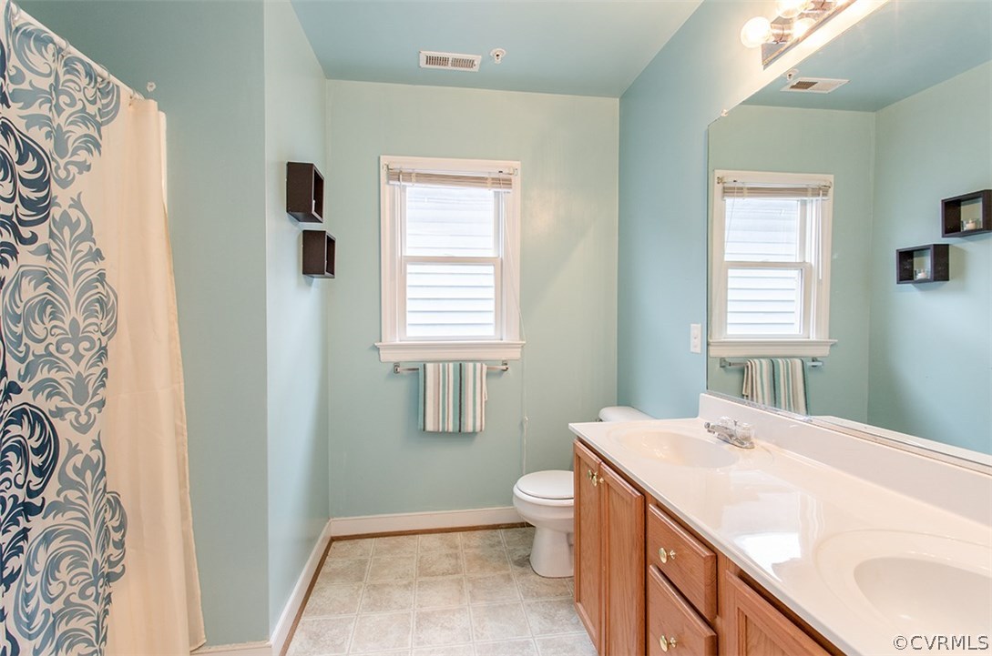1317 Decatur Street Richmond, VA 23224 - Photo 13 of 18 a spacious bathroom with a granite countertop sink a toilet and shower