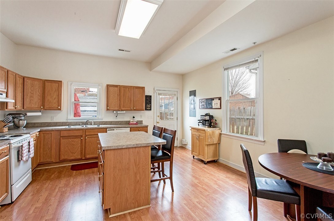1317 Decatur Street Richmond, VA 23224 - Photo 7 of 18 a kitchen with a table chairs refrigerator and cabinets
