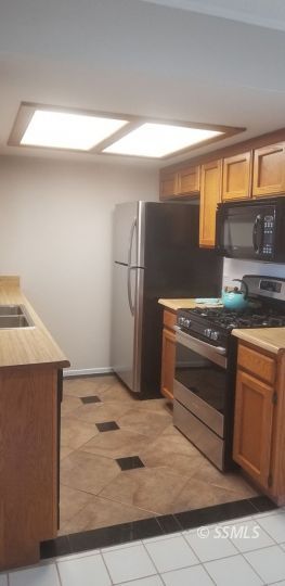 133 South Locust Street Ridgecrest, CA 93555 - Photo 24 of 26 a kitchen with a stove and a refrigerator