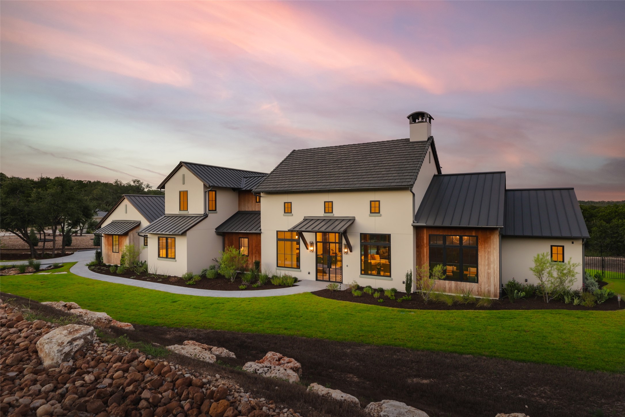 a front view of a house with a garden