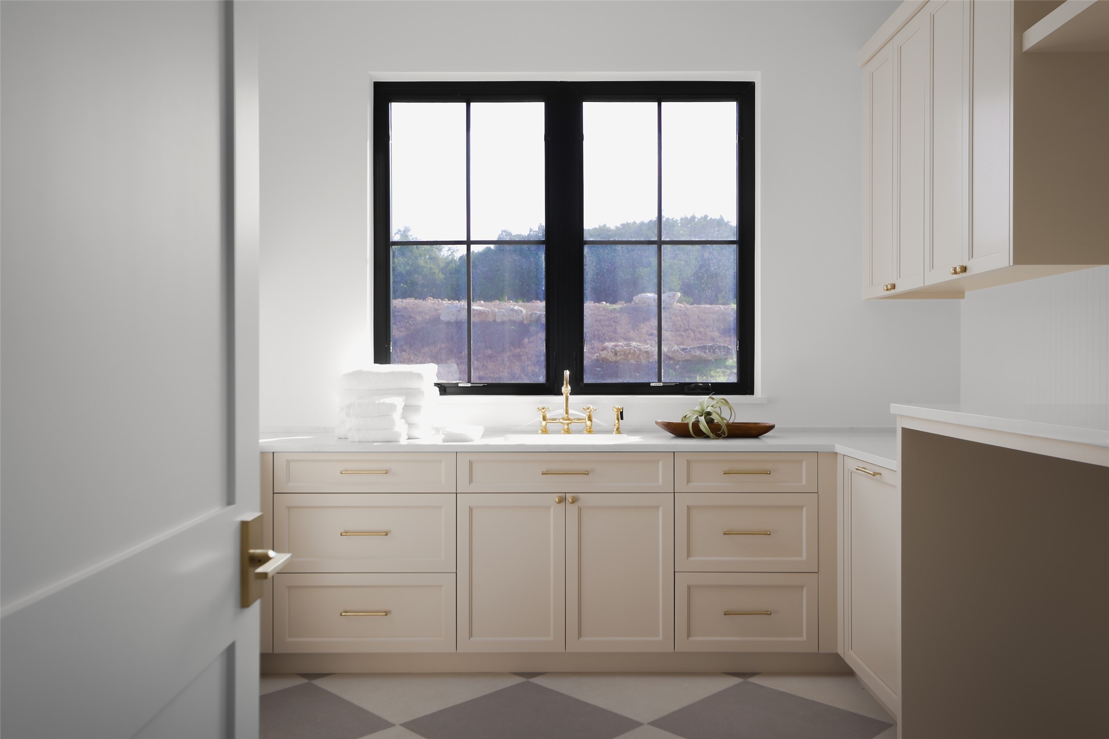 125 Broadwing Cove Austin, TX 78737 - Photo 19 of 40 A functional mudroom and laundry hub. This isn't just a utility closet; the expansive laundry room offers massive counter space for folding, a dedicated soaking sink, and built-in cabinetry. Its location near the garage entry makes it the perfect "drop zone" for a busy lifestyle.