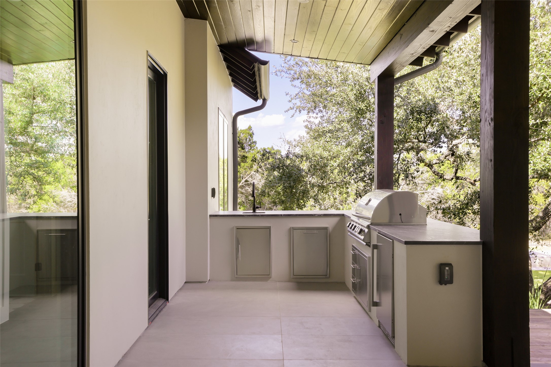 125 Broadwing Cove Austin, TX 78737 - Photo 33 of 40 The dedicated outdoor kitchen is a chef’s dream, fully equipped with Blaze appliances and stunning leathered Black Forest quartz countertops. Whether you’re hosting a summer barbecue or prepping dinner while the everyone is swimming, this setup makes outdoor entertaining effortless.