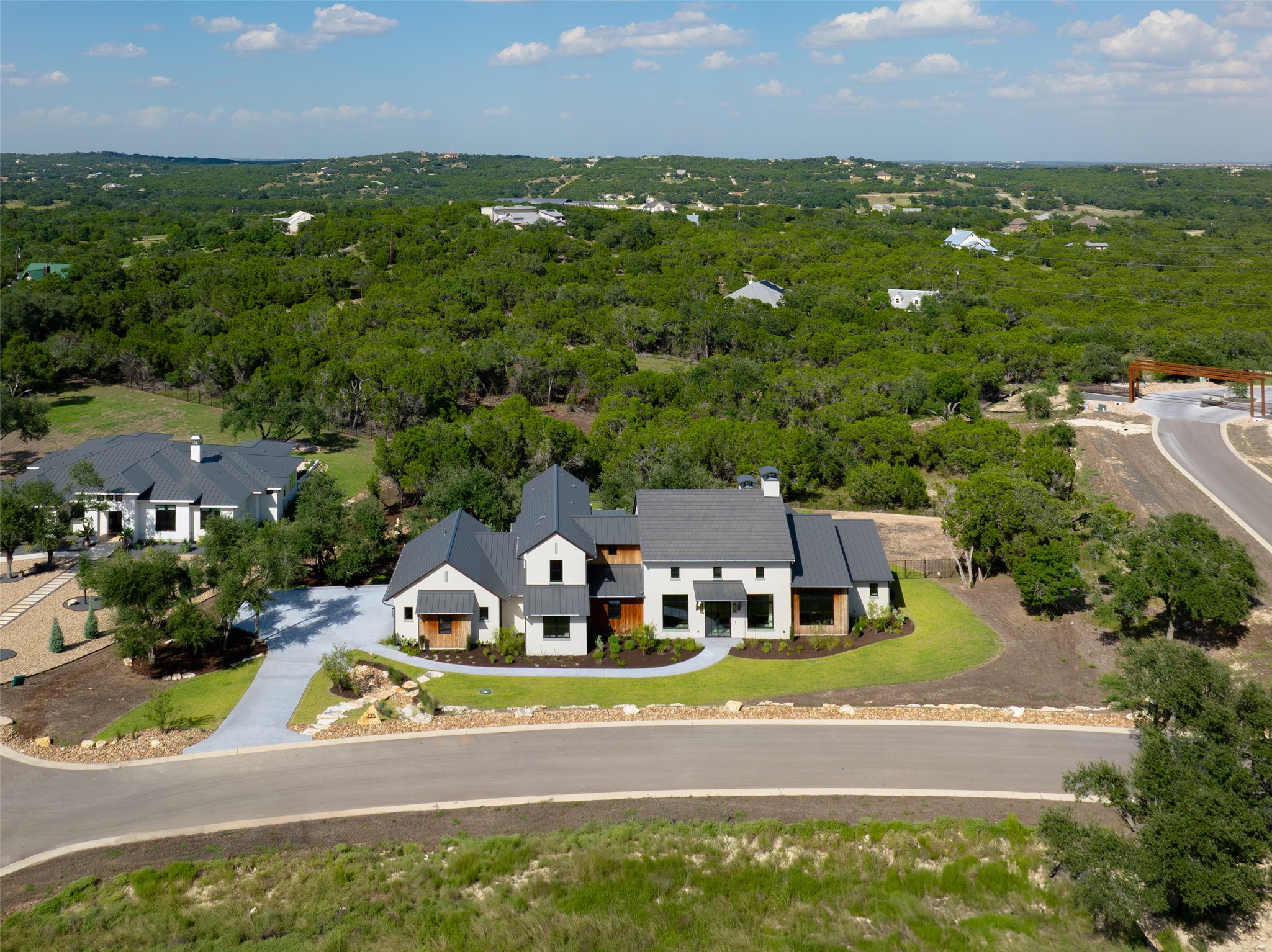 125 Broadwing Cove Austin, TX 78737 - Photo 37 of 40 an aerial view of residential houses with yard and ocean view