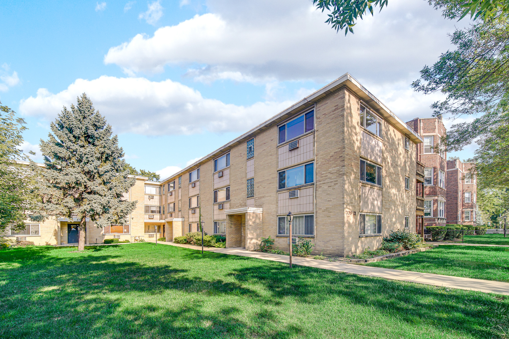 a view of a building with a yard
