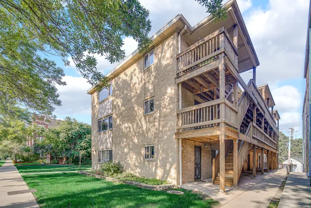a view of a large building with a yard