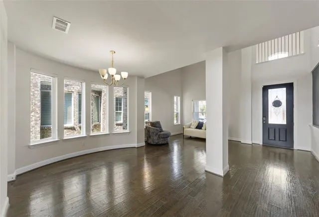a view of an livingroom with furniture wooden floor and a fireplace