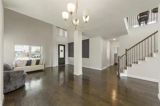 a view of a livingroom with wooden floor and a large window
