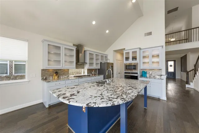 a view of kitchen island with granite countertop wooden floor and center island