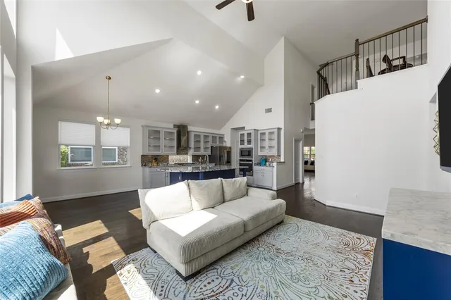 a living room with furniture and kitchen view
