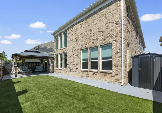 a front view of a house with a yard garden and outdoor seating
