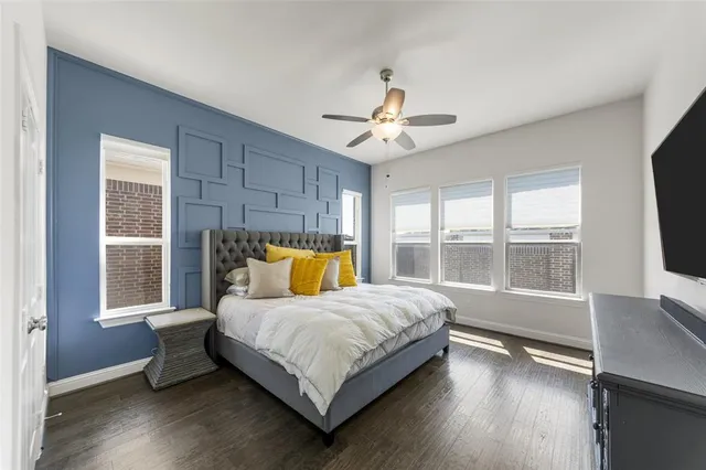 a bedroom with a bed and a large window